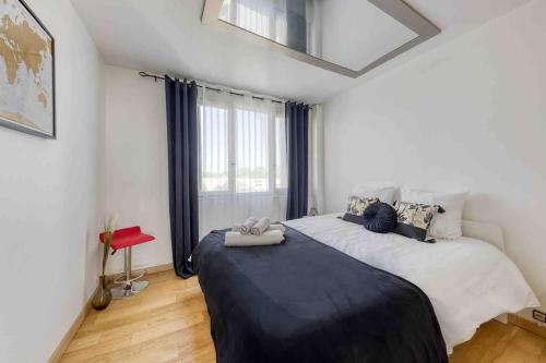 a bedroom with two beds and a large window at Flat Design St Denis 4 personnes in Saint-Denis