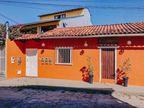 a orange house with a red roof at D'Ajuda Inn in Arraial d'Ajuda