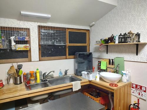 a kitchen with a sink and a counter top at Fukubatake in Yoshino