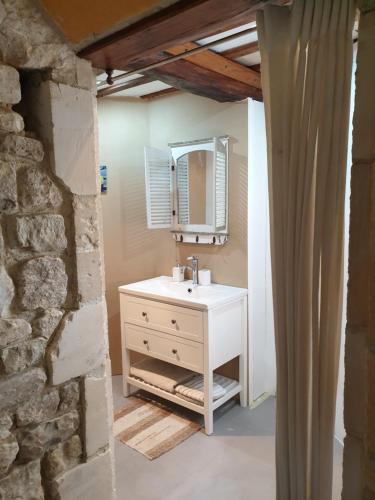 a bathroom with a white sink and a mirror at Moulin de la Bretonnière - Omaha Beach Dday in Aignerville