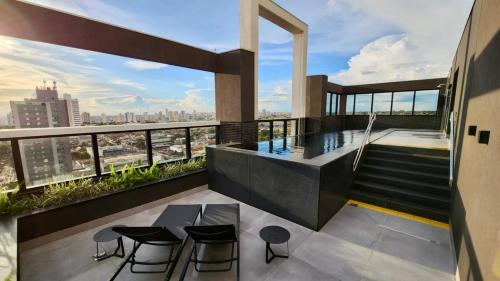 a balcony with a swimming pool on a building at Loft de Luxo c/ Home Office ao lado Shopping CG. in Campo Grande