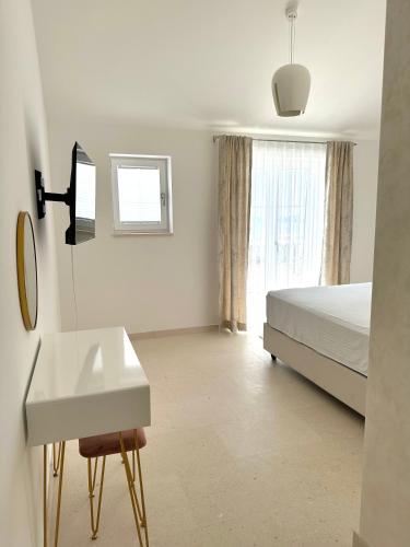 a bedroom with a bed and a sink and a mirror at Orebic Luxury Villa Leopold in Orebić