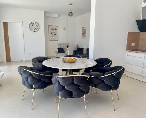 a dining room with a table and chairs at Orebic Luxury Villa Leopold in Orebić