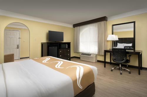 a hotel room with a bed and a desk and a computer at Quality Inn & Suites Gallup I-40 Exit 20 in Gallup