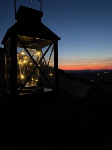 a lit up lantern sitting on top of a building at La Casa del Gelsomino in Acquaviva Picena