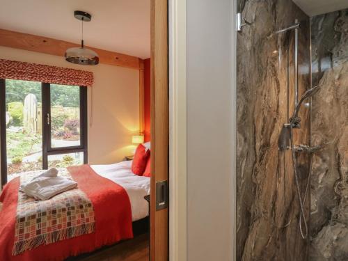 a bedroom with a bed and a shower at Fioled in Welshpool