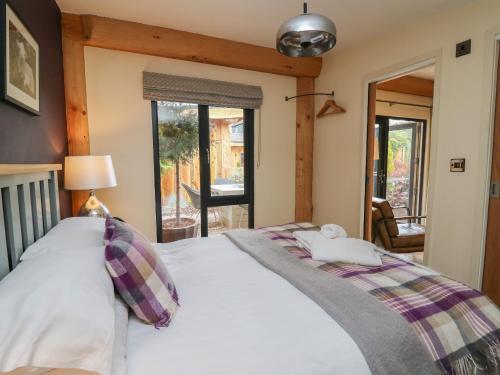 una camera da letto con un grande letto bianco e una finestra di Daffodil a Welshpool
