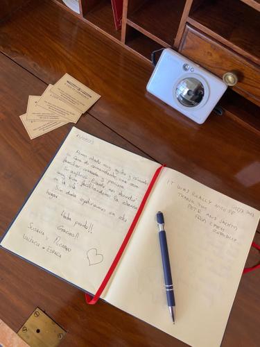 a notebook with a pen on a table with notes at A Casa do Comandante in Lagoa