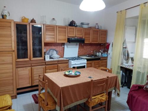 a kitchen with wooden cabinets and a table with a plate on it at Casa della Nonna in Pizzo