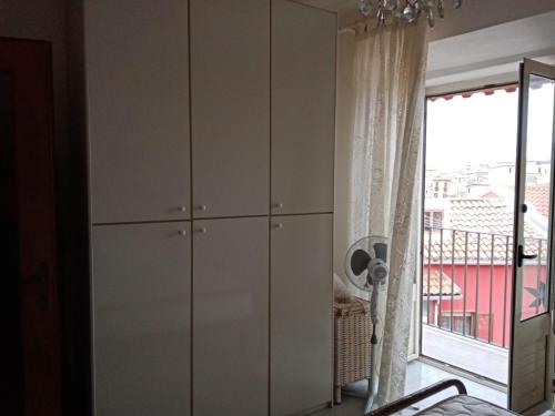 a white cabinet in a room with a window at Casa della Nonna in Pizzo