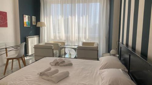 a bedroom with a bed with two towels on it at Stupenda camera vista mare con finiture di lusso in Marina di Carrara