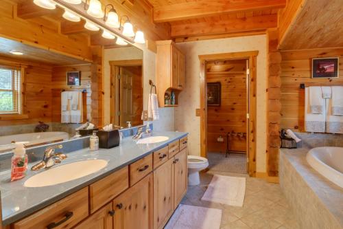 a bathroom with two sinks and a tub and a toilet at Lakefront Langley Retreat with Decks and Great Views! in Spavinaw