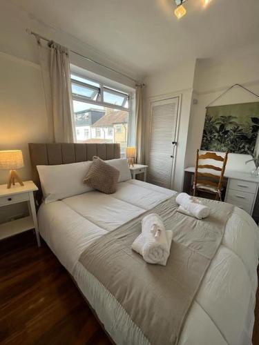 a bedroom with a bed with a towel on it at Beautiful house/Parking in Plumstead