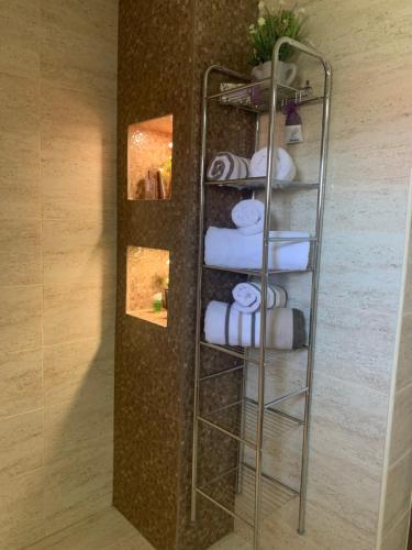 a towel rack with towels in a room at CASA LUI MOȘU in Alba Iulia