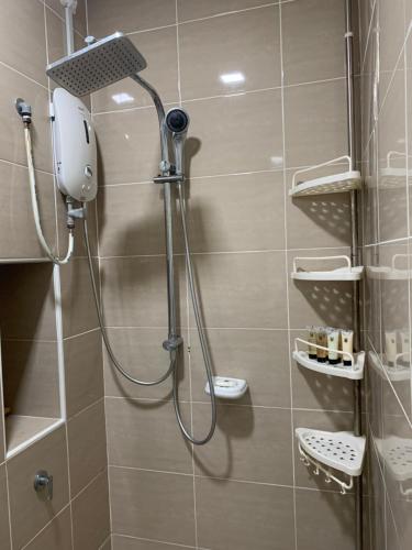a shower with a shower head in a bathroom at Ariana Roomstay @ skyloft in Johor Bahru