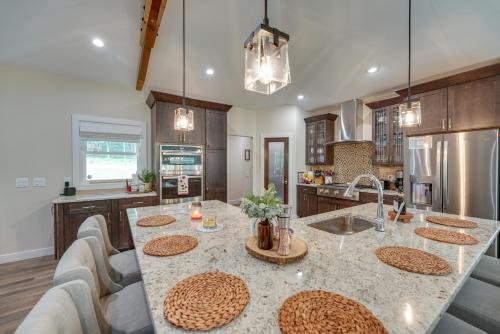 a kitchen with a large island with a sink at Dock and Yard Games Lakefront Michigan Getaway! in Free Soil