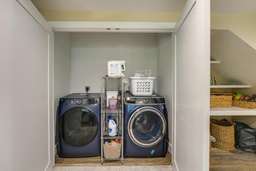 a laundry room with a washer and a dryer at Dock and Yard Games Lakefront Michigan Getaway! in Free Soil