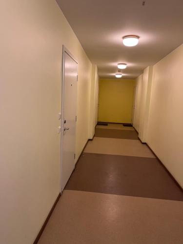 an empty hallway in an office building with a door at Mõisavälja 10 apartment in Rakvere
