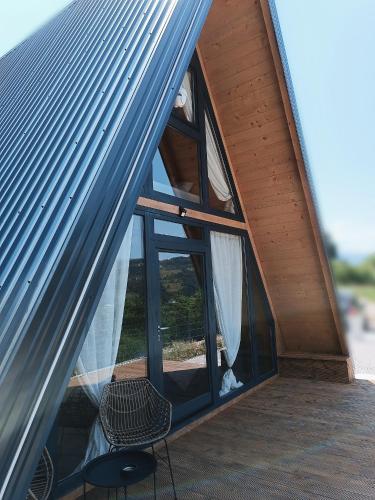 a room with a window and a chair in a house at Stone Chalets - TERRA in Jajce