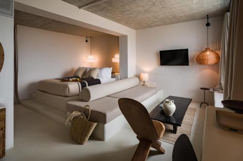 a bedroom with a bed and a couch and a tv at Euforia Retreat and Spa in Eforie Nord