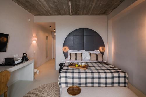 a bedroom with a bed with a black and white checkered blanket at Euforia Retreat and Spa in Eforie Nord