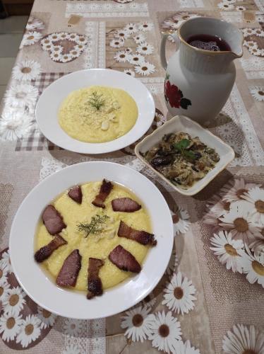 a table with plates of food and a cup of coffee at Nad Cheremoshem in Tyudiv