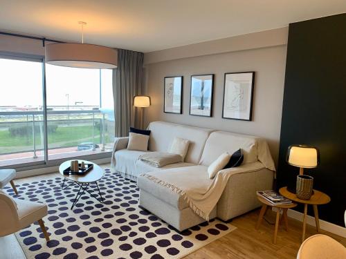 un salon avec un canapé et une table dans l'établissement Superbe Appt Face Mer 6 pers, à Le Touquet-Paris-Plage