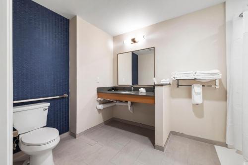 a bathroom with a toilet and a sink and a mirror at Fairfield by Marriott Inn & Suites San Francisco Airport Oyster Point Area in South San Francisco