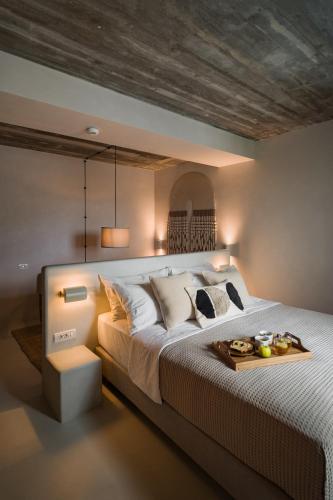 a bedroom with a large bed with a tray on it at Euforia Retreat and Spa in Eforie Nord