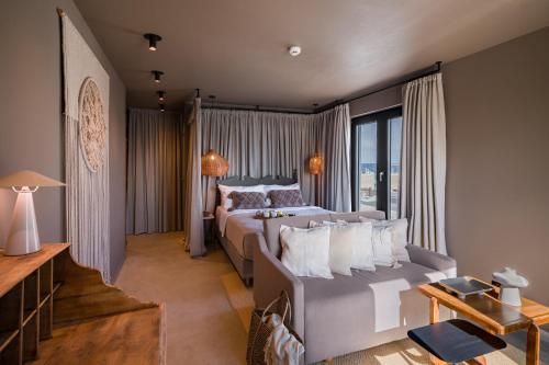 a bedroom with a bed and a large window at Euforia Retreat and Spa in Eforie Nord