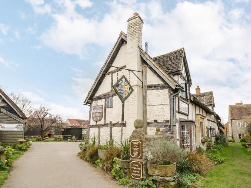 an old house with a sign in front of it at Alstroemeria in Evesham