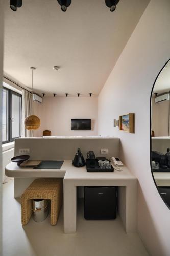 a white room with a desk and a mirror at Euforia Retreat and Spa in Eforie Nord