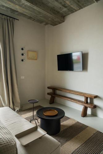 a living room with a couch and a table and a tv at Euforia Retreat and Spa in Eforie Nord