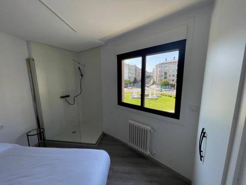 a bedroom with a window and a bed in it at LA Lujuria in Ourense
