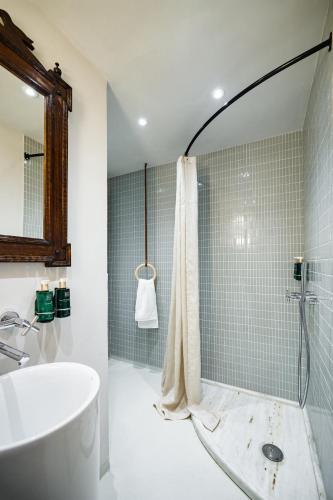 a bathroom with a shower and a sink and a tub at Euforia Retreat and Spa in Eforie Nord