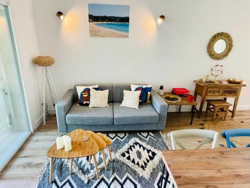 een woonkamer met een bank en een tafel bij Cala Rossa by Saraï, Apt T2 4 personnes, dans Résidence hôtelière avec piscine in Lecci