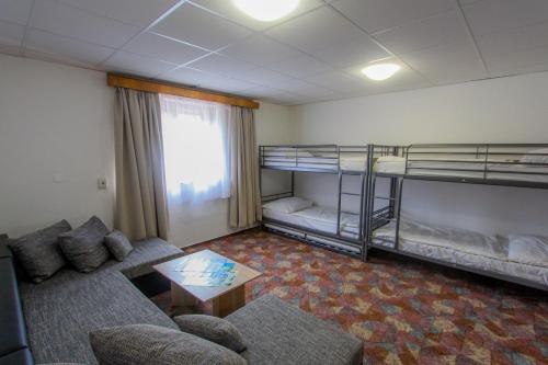 a living room with two bunk beds and a couch at Chata Biela Stopa in Tatranská Lomnica