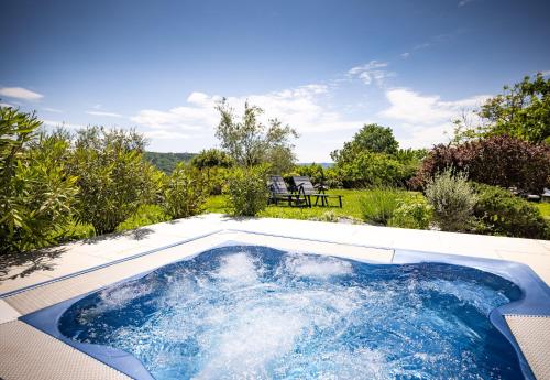 a hot tub in the backyard of a house at Casa Rustica 1838 in Sovinjak