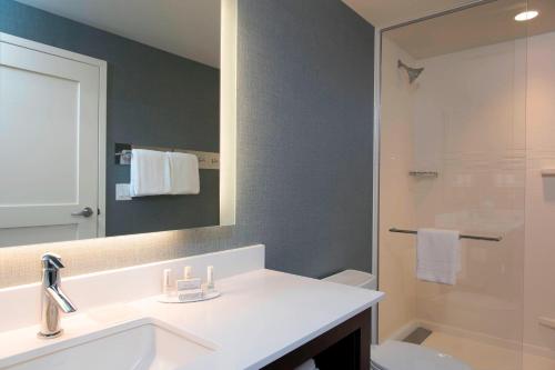 a bathroom with a sink and a toilet and a mirror at Residence Inn by Marriott Ann Arbor Downtown in Ann Arbor