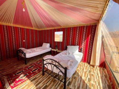 a room with two beds in a tent at Desert's Soul Wadi Rum in Disah