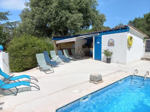 a patio with chairs and a swimming pool at GITES de Plos Appart CHALET PISCINE SPA in Anduze