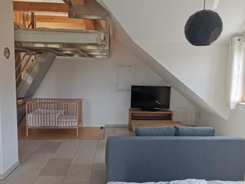 a living room with a couch and a tv at Ferienwohnung Meyer Obergeschoss in Weißenburg in Bayern