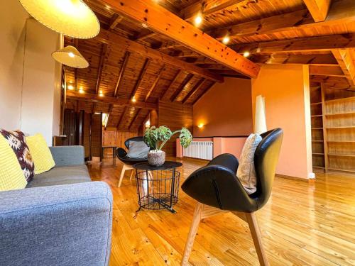 a living room with chairs and a couch and a table at Casa Elegancia, Pleta de Saga in Ger