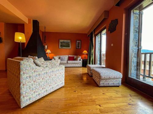 a living room with two couches and a fireplace at Casa Elegancia, Pleta de Saga in Ger