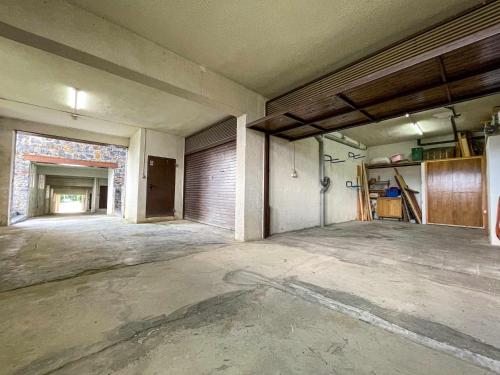 an empty room with a garage in a building at Casa Elegancia, Pleta de Saga in Ger