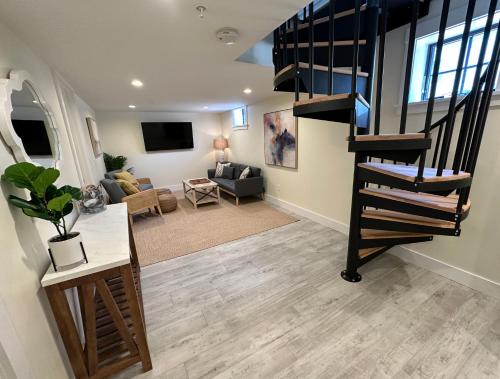 a living room with a spiral staircase in a house at Prime Location! Renovated House! 6 Bed4 Bath in Newport