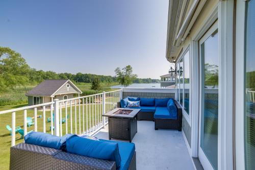 a patio with couches and a table on a balcony at Jackson Lakefront Getaway with Balcony, Dock Access in Jackson