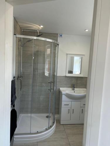 a bathroom with a shower and a sink at A new built brick chalet in Leysdown-on-Sea