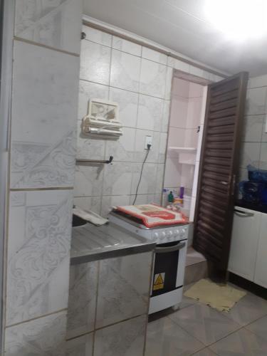 a kitchen with a counter and a sink in a room at Cantinho da Biu in Maragogi