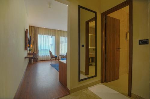 a hallway with a door leading to a living room at Hotel Escala By Levelup in Amritsar